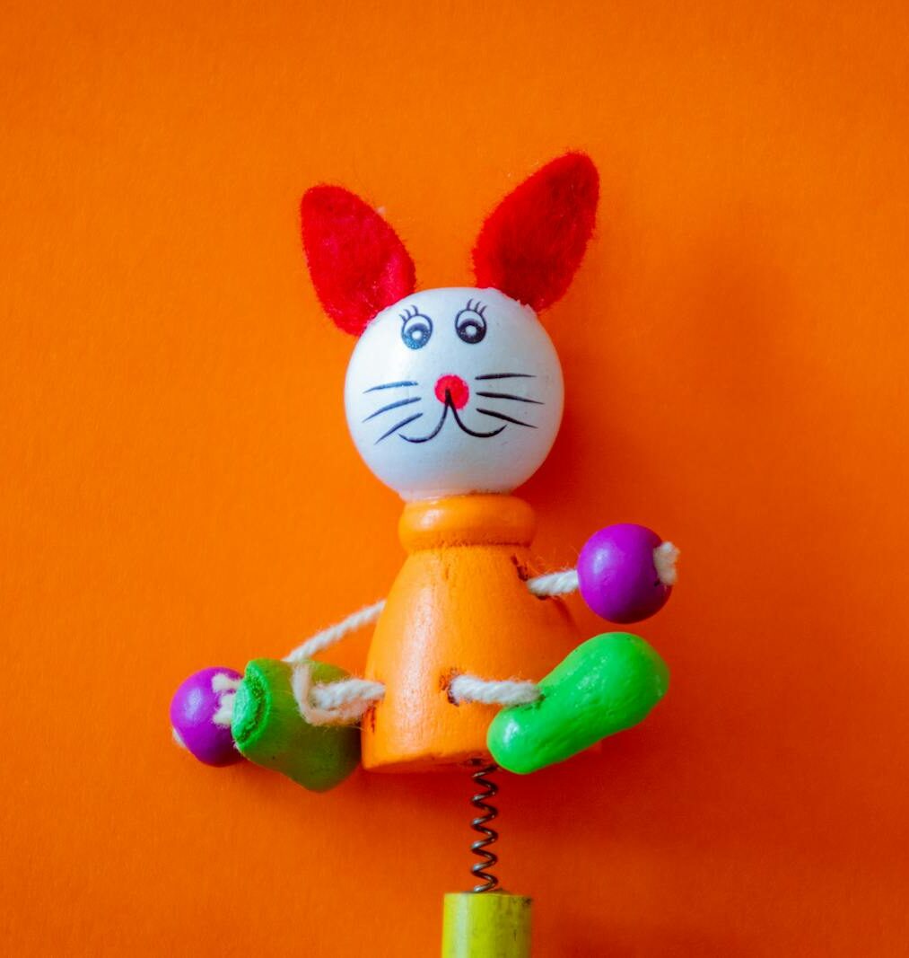 Close-up of a colorful wooden rabbit toy with bright colors and playful design.